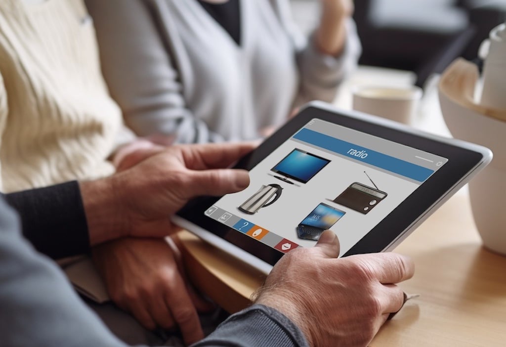 An older man holding an iPad running Cuespeak matching module